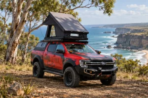 Rooftop tent weight in practice: an aluminium hard shell tent mounted on a 4WD at a coastal campsite