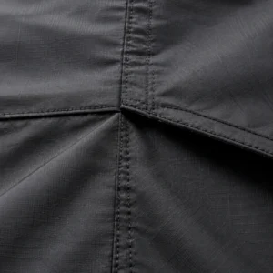Close-up of coated rooftop tent fabric with a taped seam, showing the weave of Oxford polyester cloth
