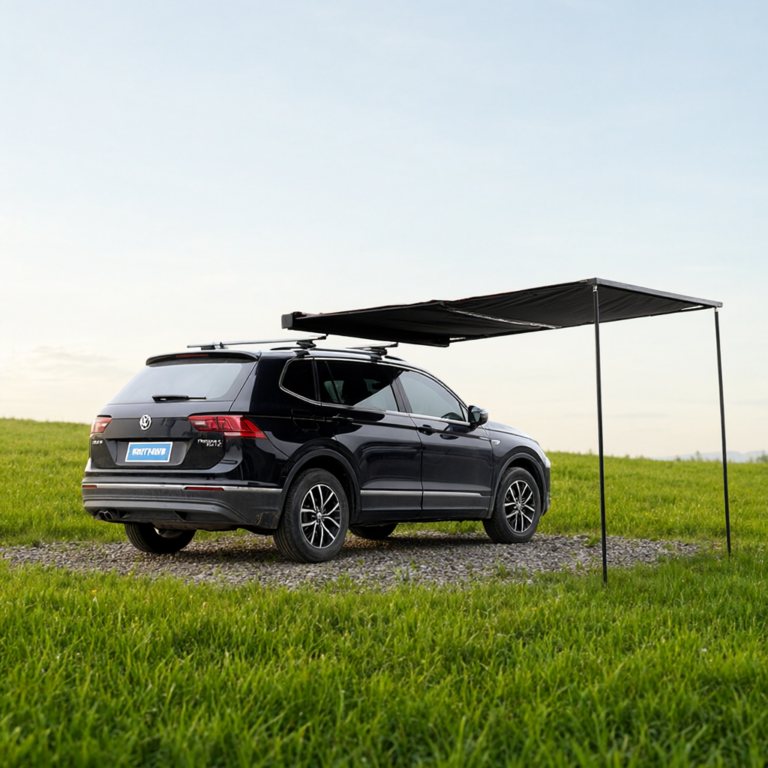 Vehicle awning deployed from an SUV on a grass field