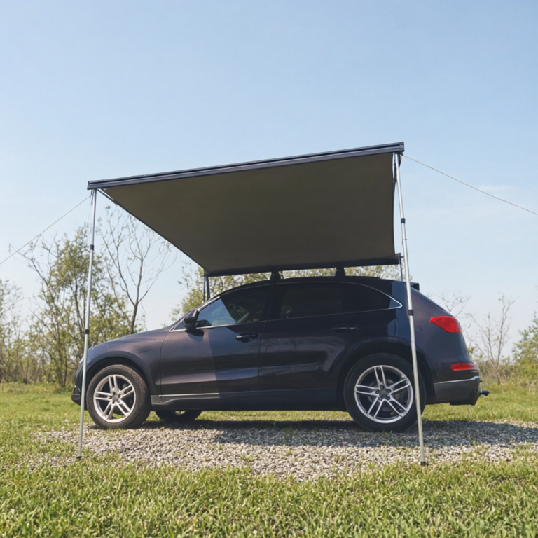 Free standing 4WD awning with support poles on a gravel pitch